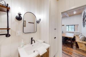 a bathroom with a sink and a mirror and a desk at River House in North Creek +34 photos