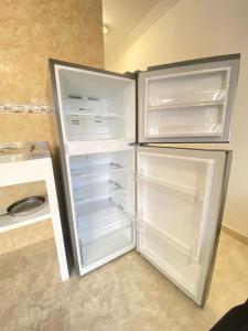 an empty refrigerator with its door open in a kitchen at Cartagena Visible Casa de Huéspedes in Cartagena de Indias