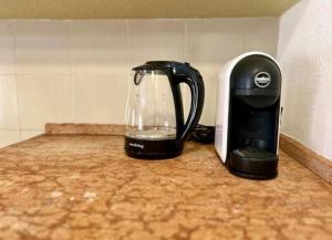 a coffee pot sitting on a counter next to a toaster at NURAS - Gioberti Charme House in Alghero