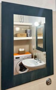 a bathroom with a sink and a mirror at NURAS - Gioberti Charme House in Alghero +24 photos