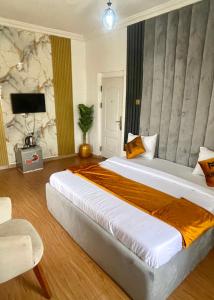 a bedroom with a large bed in a room at Montevar Hotel in Benin City