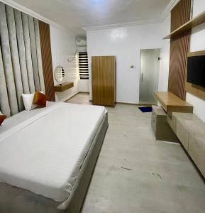 a bedroom with a large white bed in a room at Montevar Hotel in Benin City