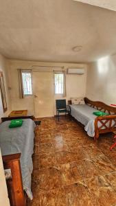 a bedroom with two beds and a chair in it at Hospedaje SUEÑO URBANO in Córdoba