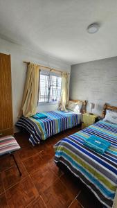 a bedroom with two beds and a window at Hospedaje SUEÑO URBANO in Córdoba +28 photos