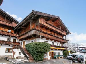 a wooden building with a staircase in front of it at Zellner Top 9 in Alpbach