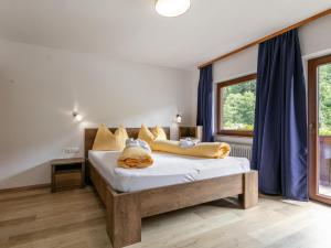 a bedroom with a large bed with blue curtains at Zellner Top 9 in Alpbach