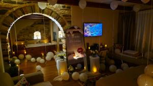 a room with balloons and candles and a room with a mirror at Cumaku Boutique Hotel & Spa in Gjirokastër +176 photos