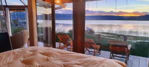 a bedroom with a bed and a view of the water at Los uros Isla atardecer in Puno