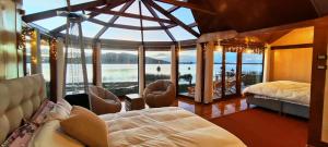 a room with a large room with a bed and a window at Los uros Isla atardecer in Puno