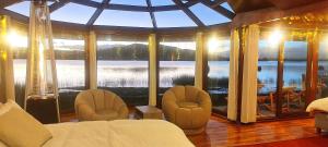 a bedroom with a large room with a large window at Los uros Isla atardecer in Puno