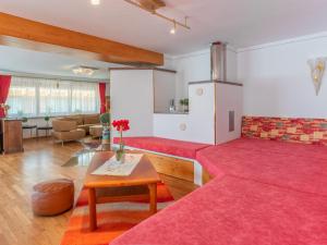 a living room with two red couches and a table at Haus am Bad in Bad Häring