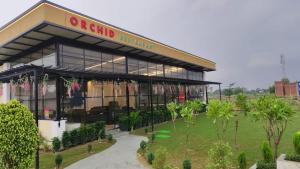 a building with a sign on the side of it at Orchid resort in Sultānpur