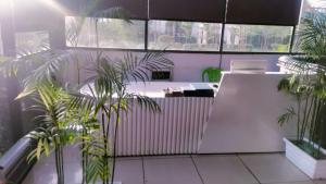 a room with some plants and a table and chairs at Orchid resort in Sultānpur