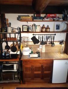 a kitchen with a sink and a counter with utensils at Le Temps Perdu in Westport