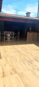a patio with tables and chairs on a building at Casa Flórida in Uberaba