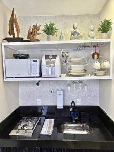 a kitchen counter with a sink and a stove at Euetu na Lapinha da Serra in Santana do Riacho +105 photos