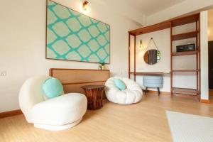 two white chairs sitting in a room at Sepilok Nature Lodge - Formerly known as Sepilok Nature Resort in Sandakan