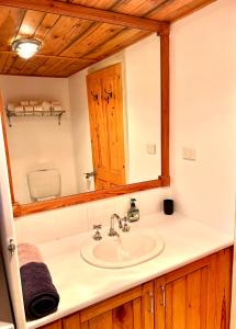 a bathroom with a sink and a mirror at 2 bedroom Guesthouse in the Centre of Noojee in Noojee +21 photos