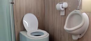 a bathroom with a toilet and a bidet at Los uros Isla atardecer in Puno