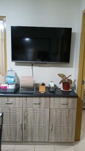 a large flat screen tv hanging on a wall at Keyspace condotel in Piapi