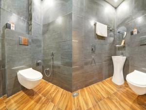a bathroom with a toilet and a shower at Hotel The Arrow International Laxmi Nagar in New Delhi