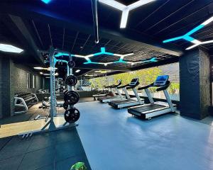 a gym with a row of treadms and pilates equipment at Neptune Luxe in Nairobi
