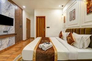 a hotel room with a bed with towels on it at Hotel The Arrow International Laxmi Nagar in New Delhi