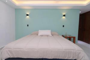 a bedroom with a large white bed in a room at Hotel Soberanis in Cancún +105 photos