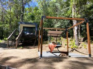a swing set with a person sitting on it at Sunset Ridge - King Bed Cabin & Breakfast Basket in Boyland