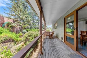 a porch of a house with a glass door at Winterwood 9 Camira Ave in Jindabyne