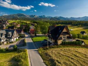 a village in the mountains with houses and a road at Pokoje gościnne u Eli i Jacka in Murzasichle