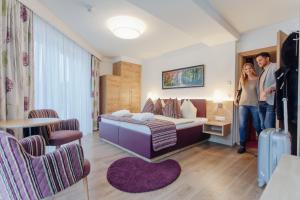 A bed or beds in a room at Wellnesshotel Aumühle