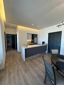 a living room with a dining table and a kitchen at Exclusive Luxury Condo 2bd in Tijuana +46 photos