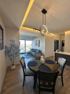 a dining room table and chairs in a living room at Exclusive Luxury Condo 2bd in Tijuana