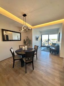 a dining room and living room with a table and chairs at Exclusive Luxury Condo 2bd in Tijuana