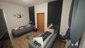 a living room with two couches and a couch at Suite Calli in Bernburg