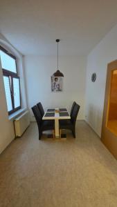 a dining room with a table and two chairs at Suite Calli in Bernburg