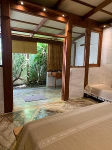 a room with a bed and a pool in it at Galería Suites San Pancho in San Francisco