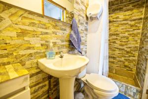 a bathroom with a sink and a toilet at Hostal Pampaloja Antof in Antofagasta +248 photos