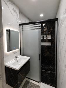 a bathroom with a sink and a shower at Dar Essalam - Mostaganem, Salamandre in Mostaganem