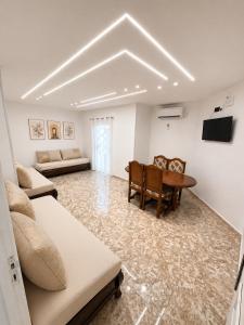 a living room with a table and a couch at Dar Essalam - Mostaganem, Salamandre in Mostaganem