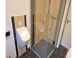 a bathroom with a shower and a toilet at Deichhuus in Neßmersiel in Neßmersiel +15 photos
