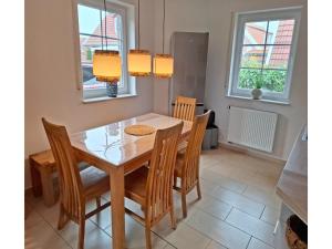 a dining room with a table and chairs at Deichhuus in Neßmersiel in Neßmersiel