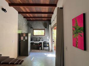 a kitchen with a refrigerator in a room at Casa Gemini in Ilha de Boipeba