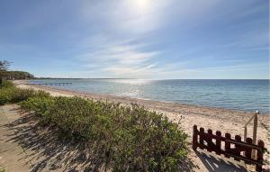 a bench on a sandy beach near the water at Beautiful Home In Haderslev With Wifi in Haderslev