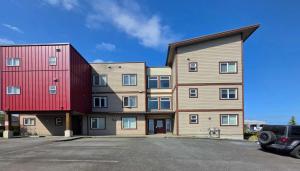 an apartment building with a red and wooden at Cold Moon Inn in Nanaimo