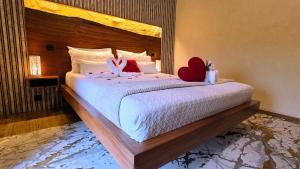 a bedroom with a bed with two stuffed animals on it at Casa Favo de Mel - Jacuzzi & Piscina - Refúgio na Montanha in Arcos de Valdevez +50 photos