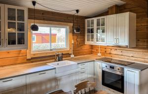 a kitchen with white cabinets and a sink at 3 Bedroom Beautiful Home In Haderslev in Haderslev