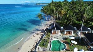 an aerial view of a resort on the beach at Ombara Resort Mentawai in Katiet