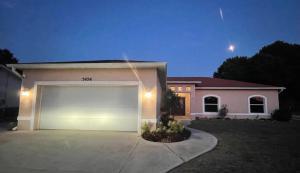 a house with a large garage in front of it at Pool Home in Englewood